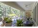 Inviting screened-in porch with comfortable seating and views of lush greenery at 1114 Clairborne Ct, Indianapolis, IN 46280