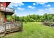 Cozy back deck overlooking a lush green yard with mature trees offering a great outdoor living space at 13151 W Youth Camp Rd, Columbus, IN 47201