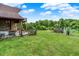Expansive backyard featuring a spacious deck, a hot tub, and mature trees, perfect for outdoor gatherings at 13151 W Youth Camp Rd, Columbus, IN 47201
