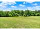 Lush backyard with mature trees at 13151 W Youth Camp Rd, Columbus, IN 47201