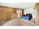 Basement bedroom with wood paneling, an inviting doorway and plush carpeting at 13151 W Youth Camp Rd, Columbus, IN 47201