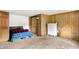 Cozy basement bedroom featuring wood paneling, a comfortable bed, and ample storage space at 13151 W Youth Camp Rd, Columbus, IN 47201