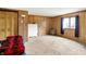 Basement bedroom with carpet floors, wood paneling and a window with curtains at 13151 W Youth Camp Rd, Columbus, IN 47201