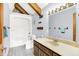 Bathroom features a single vanity, shower/tub combo, wood accents, and gray paint at 13151 W Youth Camp Rd, Columbus, IN 47201
