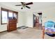Bright bedroom with carpet floors, neutral walls, and a view into the kitchen at 13151 W Youth Camp Rd, Columbus, IN 47201