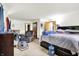 Comfortable bedroom with neutral carpeting, an accent chair, and a king sized bed with storage underneath at 13151 W Youth Camp Rd, Columbus, IN 47201