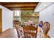 Open dining room features stone fireplace, hardwood floors, and a view to the front entry at 13151 W Youth Camp Rd, Columbus, IN 47201