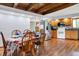 Dining area showcases hardwood floors, wood beamed ceilings, stainless steel appliances, and eat-in kitchen at 13151 W Youth Camp Rd, Columbus, IN 47201