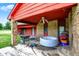 Exterior features a lower deck with furniture, grill, and an inflatable hot tub at 13151 W Youth Camp Rd, Columbus, IN 47201