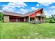 The unique home with stone accents, dual decks, and lush lawn at 13151 W Youth Camp Rd, Columbus, IN 47201
