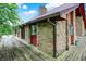 Exterior stone and red cedar detail with wrap around deck at 13151 W Youth Camp Rd, Columbus, IN 47201