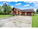 Charming home featuring stone accents, a two-car garage, and long driveway at 13151 W Youth Camp Rd, Columbus, IN 47201