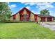 Charming home featuring stone accents, a two-car garage, and a spacious front yard at 13151 W Youth Camp Rd, Columbus, IN 47201