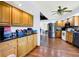 Bright eat-in kitchen with stainless steel appliances, hardwood floors, and wood cabinets at 13151 W Youth Camp Rd, Columbus, IN 47201