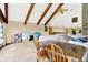 Spacious living area with vaulted ceilings, wood beams, and view of the stone fireplace at 13151 W Youth Camp Rd, Columbus, IN 47201