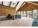 Large living area features vaulted ceilings, wood beams, and a view to the exterior at 13151 W Youth Camp Rd, Columbus, IN 47201