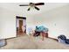 Standard living room featuring neutral carpet, ceiling fan and view into the dining room at 13151 W Youth Camp Rd, Columbus, IN 47201