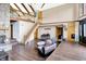 Spacious living room featuring a stone fireplace and an open staircase at 13151 W Youth Camp Rd, Columbus, IN 47201