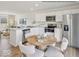 Modern kitchen featuring stainless steel appliances, white cabinets, a large island, and round table in an inviting eat-in space at 1334 Aster Dr, Shelbyville, IN 46176