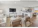 Open-concept living space with modern furnishings, hardwood floors, connecting the living room, kitchen, and dining areas at 1334 Aster Dr, Shelbyville, IN 46176