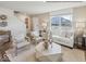Bright living room with large windows, neutral tones, and stylish decor including a unique geometric coffee table at 1334 Aster Dr, Shelbyville, IN 46176