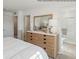 Comfortable primary bedroom with a dresser, mirror and access to an ensuite bathroom featuring modern fixtures and finishes at 1334 Aster Dr, Shelbyville, IN 46176