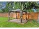 Backyard gazebo featuring curtains and a patio on a sunny day, perfect for outdoor enjoyment at 1420 E Loretta Dr, Indianapolis, IN 46227