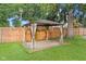 Backyard gazebo featuring curtains and a patio surrounded by greenery, creating a serene outdoor space at 1420 E Loretta Dr, Indianapolis, IN 46227