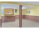 Spacious finished basement featuring paneled walls, tile flooring, and ample lighting for a flexible living space at 1420 E Loretta Dr, Indianapolis, IN 46227