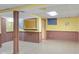 Finished basement showcasing wainscoting, a window, bright walls, and tile flooring for a warm living space at 1420 E Loretta Dr, Indianapolis, IN 46227