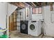 Unfinished basement with washer and dryer hookups providing practical space for laundry and storage at 1420 E Loretta Dr, Indianapolis, IN 46227