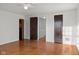 Spacious bedroom with hardwood floors, white walls and trim, and access to additional rooms at 1420 E Loretta Dr, Indianapolis, IN 46227