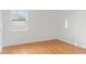 Bright bedroom featuring hardwood floors and a large window at 1420 E Loretta Dr, Indianapolis, IN 46227