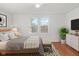 Cozy bedroom with wood floors, bright windows, and contemporary furnishings for relaxation at 1420 E Loretta Dr, Indianapolis, IN 46227