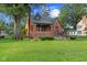 Charming brick home with a well-manicured lawn and inviting front porch at 1420 E Loretta Dr, Indianapolis, IN 46227