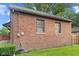 Exterior of the home showing the brick siding, several windows, green lawn, and nearby landscaping at 1420 E Loretta Dr, Indianapolis, IN 46227