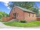 Charming brick home with a green roof, featuring a small porch, well-maintained lawn, and traditional architectural details at 1420 E Loretta Dr, Indianapolis, IN 46227