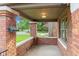 Inviting brick porch with seating area perfect for enjoying the outdoors at 1420 E Loretta Dr, Indianapolis, IN 46227