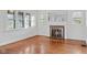 Bright living room featuring a cozy fireplace, large windows, and hardwood floors at 1420 E Loretta Dr, Indianapolis, IN 46227