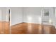 Sunlit living room with gleaming hardwood floors and arched doorways at 1420 E Loretta Dr, Indianapolis, IN 46227
