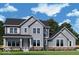 Charming two-story home showcasing gray siding, black roof and complemented by professionally landscaped yard at 19614 Wood Farm Pl, Westfield, IN 46074