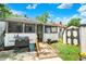 Backyard showing the white exterior with a screened in porch and additional storage sheds at 2029 N Colorado Ave, Indianapolis, IN 46218