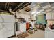 Unfinished basement with washer dryer hookups, concrete floors, and partial cabinets at 2029 N Colorado Ave, Indianapolis, IN 46218