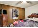 Bedroom features wood paneled walls, a ceiling fan, and a window with black curtains at 2029 N Colorado Ave, Indianapolis, IN 46218