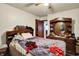 Bedroom with wooden furniture and a ceiling fan next to another room at 2029 N Colorado Ave, Indianapolis, IN 46218