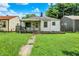 Charming single story home with a covered porch and a well maintained lawn at 2029 N Colorado Ave, Indianapolis, IN 46218