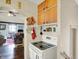 Open kitchen with cabinets, an electric stovetop, and a view into the living room at 2029 N Colorado Ave, Indianapolis, IN 46218
