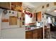 Kitchen with wooden cabinets, a stainless steel sink, and a view into the dining room at 2029 N Colorado Ave, Indianapolis, IN 46218