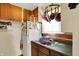 Cozy kitchen features wood cabinets, window, and a pot rack with red cookware at 2029 N Colorado Ave, Indianapolis, IN 46218