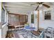 Enclosed patio features white siding, indoor/outdoor carpet, and a dining area at 2029 N Colorado Ave, Indianapolis, IN 46218